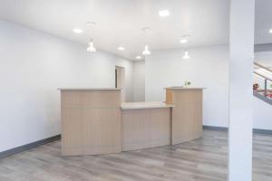 an empty office with a reception desk in a room at Travelodge by Wyndham Elkhart in Elkhart