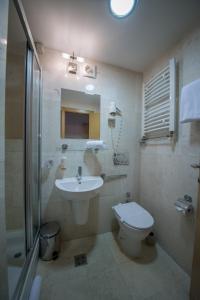 a bathroom with a sink and a toilet and a shower at Putnik Inn Belgrade in Belgrade +38 photos