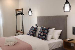 a bedroom with a large bed with pillows at La Panadería in El Rompido