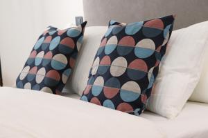 two pillows sitting on top of a bed at La Panadería in El Rompido