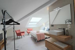 a bedroom with a bed and a mirror and a sink at La Panadería in El Rompido