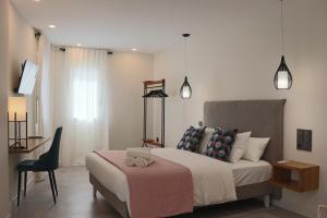 a bedroom with a bed with a desk and a chair at La Panadería in El Rompido