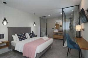 a bedroom with a large bed and a desk at La Panadería in El Rompido