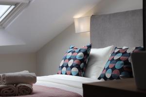 a bedroom with a bed with two pillows at La Panadería in El Rompido