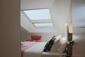 a bedroom with a bed with a skylight at La Panadería in El Rompido