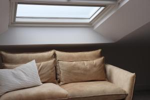a couch in a room with a window at La Panadería in El Rompido