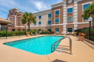 a swimming pool in front of a building at Comfort Inn & Suites Wildwood - The Villages in Wildwood