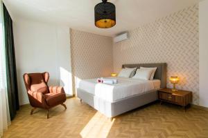 a bedroom with a white bed and a chair at Royal Residence Maiden Tower in Istanbul