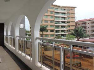 a balcony with a view of a building at HAPPY WELCOME Biétry 3 - MARCORY ZONE 4 in Abidjan