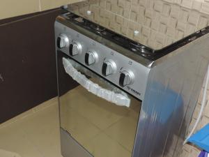 a stainless steel stove with snow on the oven at HAPPY WELCOME Biétry 3 - MARCORY ZONE 4 in Abidjan