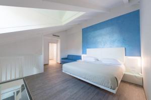 a bedroom with a white bed and a blue wall at Grand Hotel Liberty in Riva del Garda
