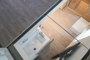 an overhead view of a white refrigerator on a wooden floor at Grand Hotel Liberty in Riva del Garda