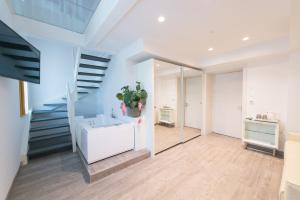a bathroom with a staircase and a white sink at Grand Hotel Liberty in Riva del Garda