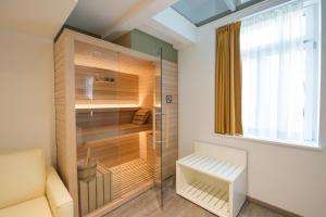 a walk in shower in a bathroom with a glass door at Grand Hotel Liberty in Riva del Garda