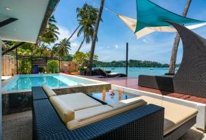 a villa with a swimming pool and a resort at Dreambeach 2-villas in Panwa Beach