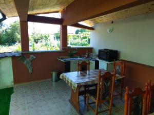 a small kitchen with a table and a microwave at Prostor Guest House in Byala