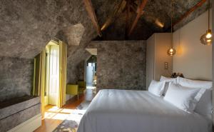 a bedroom with a large white bed in a room at Vila Foz Hotel & SPA - member of Design Hotels in Porto