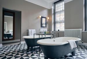 a bathroom with a large tub and a sink at Hotel du Vin Birmingham in Birmingham