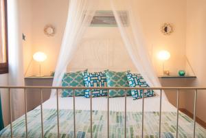 a bedroom with a bed with a canopy at Casa Danilo in San Teodoro
