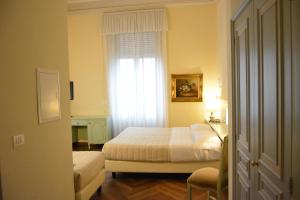 a small bedroom with a bed and a window at Grand Hotel Liberty in Riva del Garda