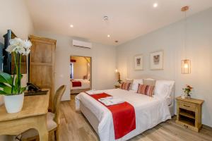 a bedroom with a large white bed and a desk at Viewpoint Boutique Living in Xlendi