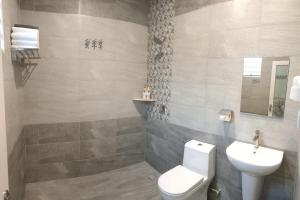 a bathroom with a toilet and a sink at Just Austin Guesthouse in Ipoh