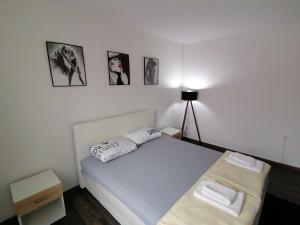a bedroom with a bed with two towels on it at Apartment ELLA in Tuzla