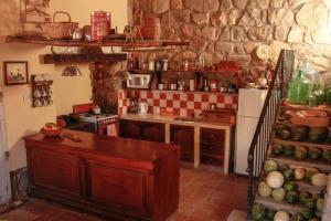 a kitchen with a counter and a refrigerator at El Rastrojo - Casa de campo in Tilcara