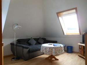 a living room with a couch and a table at Haus-Nordseemelodie-Wohnung-9 in Wittdün