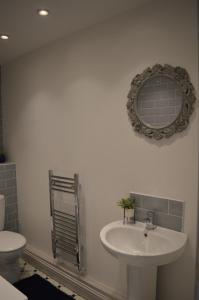 a bathroom with a sink and a mirror on the wall at Foxhill Bank in Oswaldtwistle
