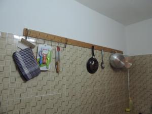 a kitchen counter with utensils on a tiled wall at HAPPY WELCOME Biétry 3 - MARCORY ZONE 4 in Abidjan +25 photos