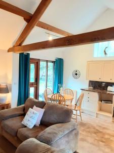 a living room with a couch and a table at Irfon Cottage in Builth Wells