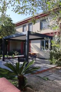 a patio with a black canopy in front of a building at B&B Villa Nora in Quartu SantʼElena