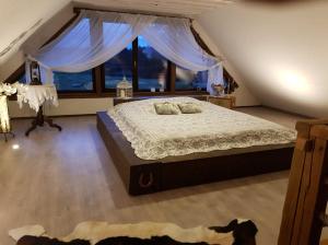 a bedroom with a large bed with blue curtains at Maamehe golfi talu 