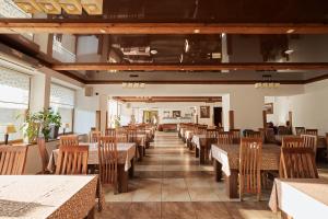 an empty dining room with tables and chairs at Pansionat Slavskiy in Slavske