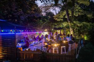 a group of people sitting at a restaurant at night at Camping de la Bageasse in Brioude +37 photos