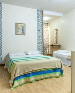 Säng eller sängar i ett rum på Hotel Pousada Icaraí