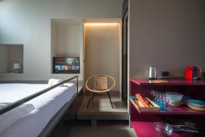 a bedroom with a bed and a table with a chair at Palazzo Scammacca in Catania