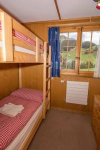 a room with two bunk beds and a window at Chalet Happy in Adelboden