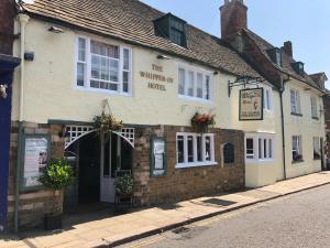 a building on the corner of a street at The George Inn in Oakham