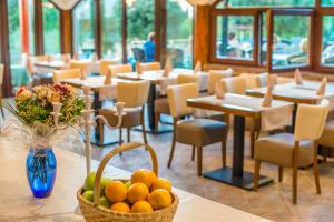 a room with tables and chairs and a basket of oranges at Hotel Villa Vrsar in Vrsar
