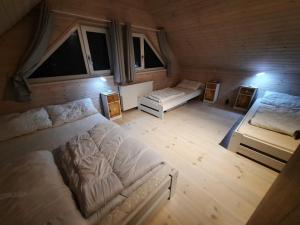 an aerial view of a bedroom with two beds at Holiday Homes 777 in Karwia