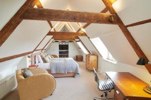 a attic bedroom with a bed and a desk at The Tower Rooms in Fakenham