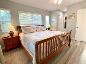 a bedroom with a large bed and two windows at Endless Summer, North Captiva Island in North Captiva +26 photos