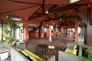 a lobby of a building with chairs and tables at ibis Styles Segre in Segré