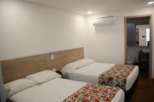 Krevet ili kreveti u jedinici u okviru objekta Hotel Poma Rosa