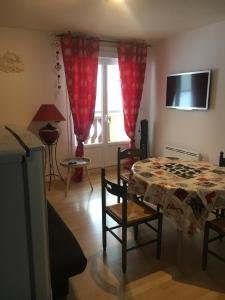 a living room with a table and a window at Résidence les campenes in Les Rousses