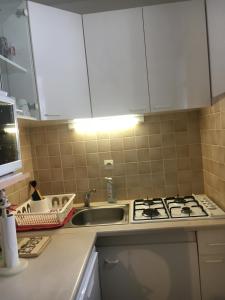 a kitchen with a sink and a stove top oven at Résidence les campenes in Les Rousses