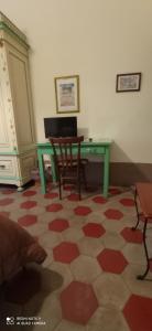 a room with a table and a chair and a desk at Casa Cristina in Syracuse