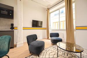 a living room with two chairs and a glass table at MBM - Marais in Paris